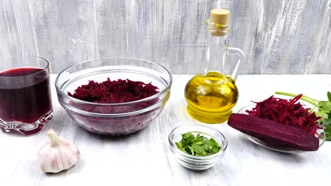 Glass with a beet juice and beetroot salad in a bowl stand on a table Stock Footage 171086556