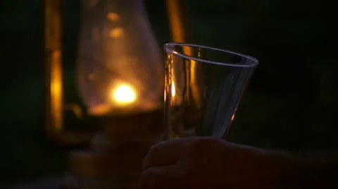 Glass being filled with bear in front of lamps Stock Footage 12658053