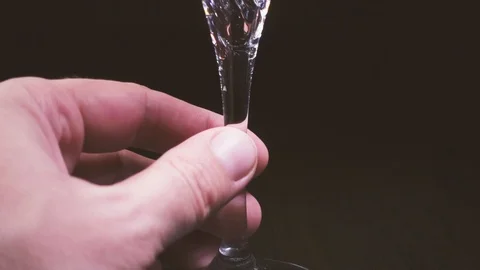 In a glass on a black background, wine is poured from the decanter slow mo Vídeo Stock 87468422