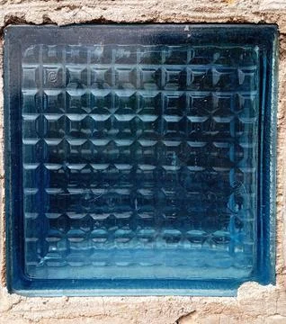 Glass block embedded in a brick wall Stock Photos