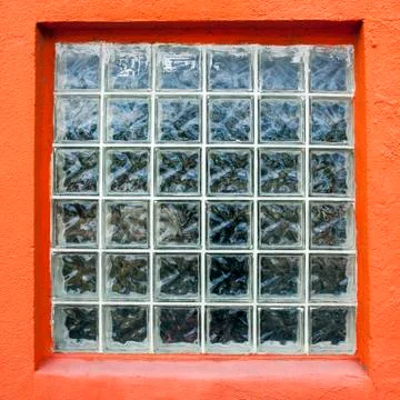 Glass block window with orange frame Foto stock