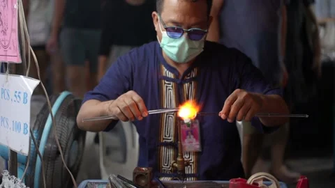 Glass Blower Forms Figurine at Night Market in Chiang Mai, Thailand Stock Footage 234849595