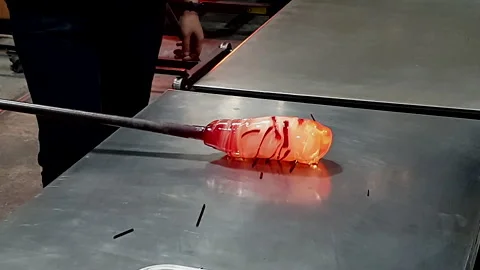 Glass blowing making pattern process use melted heated glass to attached wi.. Stock Footage 241432765