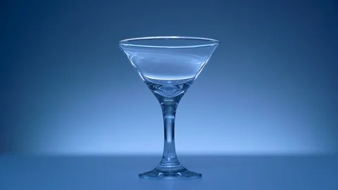Glass on blue background Видео 104369693