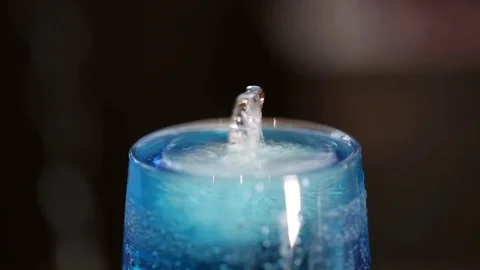 A glass of blue cold drink, floating polar bear-shaped ice Stock Footage 71025373