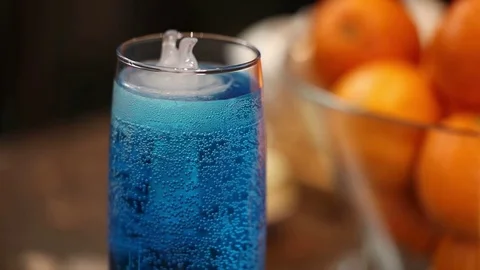 A glass of blue cold drink, floating polar bear-shaped ice Stock Footage 71025549