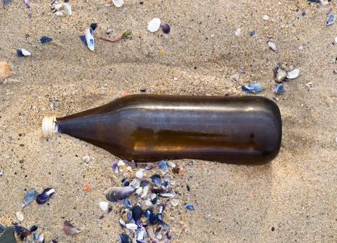 Glass bottle on the beach Stock Photos