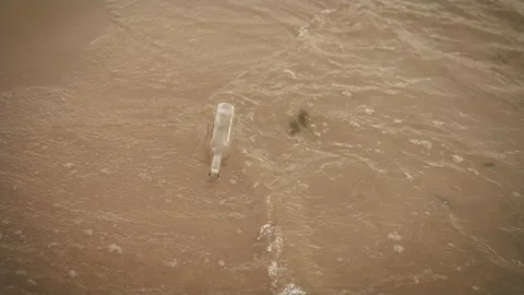 Glass bottle garbage trash in ocean. Used wine bottle floating in sea water Video stock 252262879