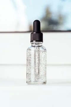 Glass bottle with liquid with bubbles. Front view Stock Photos