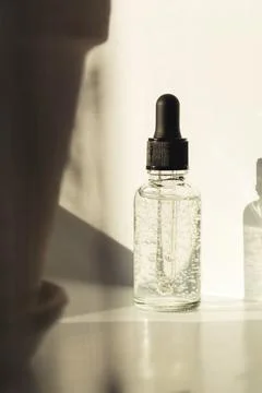 Glass bottle with liquid with bubbles. Front view Stock Photos