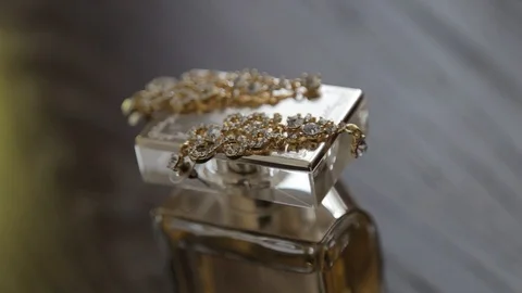 Glass bottle of perfume and luxury jewellery isolated on white Видео 123836070