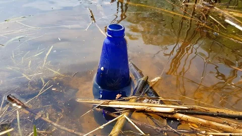 Glass bottle in the river Stock Footage 89004826