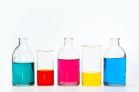 Glass bottles and flasks of different sizes with liquids of different colors on Stock Photos