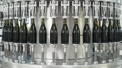 Glass bottles on the automatic conveyor line at the champagne or wine factory Stock Footage 105678224