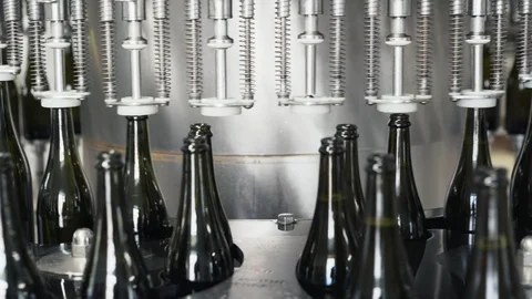 Glass bottles on the automatic conveyor line at the champagne or wine factory Video stock 105893309