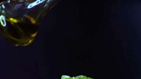 In a glass bowl with a salad olive oil pours. Stock Footage