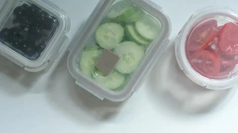 Glass boxes with vegetables on a white background close-up top view. Stock Footage 286284070