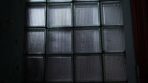 Glass bricks pattern window in a dark room with reflection lighting close-up. Stock Footage 108001947