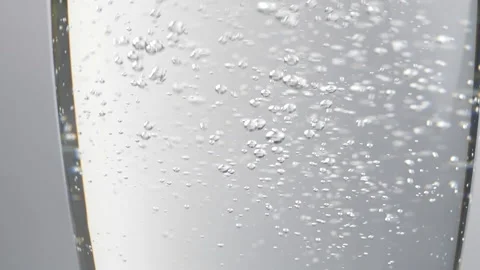 Glass with bubbles going up in slow motion, Refreshing carbonated soda drink Stock Footage 134304229