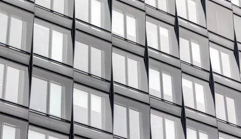 Glass building facade with window rows. Urban architecture pattern. Stock Photos