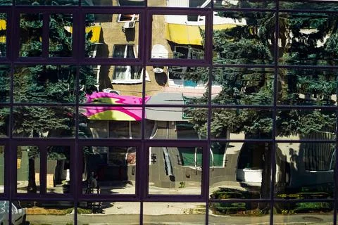 A glass building, a reflection in a window, a distorted world through a window Stock Photos