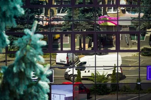 A glass building, a reflection in a window, a distorted world through a window Stock Photos
