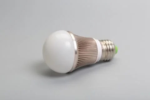 Glass bulb and miniature workers on gray background Stock Photos
