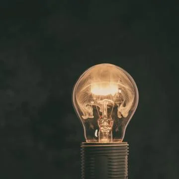 A glass bulb mounted in socket with flame inside Stock Photos
