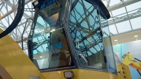 Glass cabin with multiple control levers in a construction tractor Stock Footage 111136300