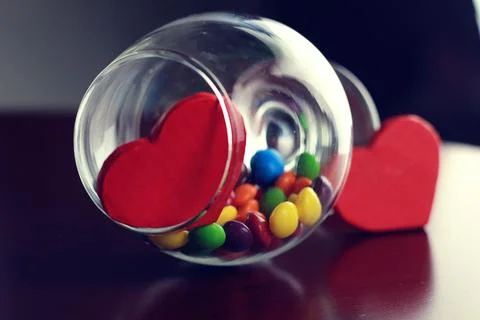 Glass with candy pill Stock Photos