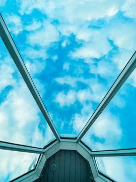 Glass Ceiling of an Glass Igloo Looking Up into the Cloudy Sky Stock Photos