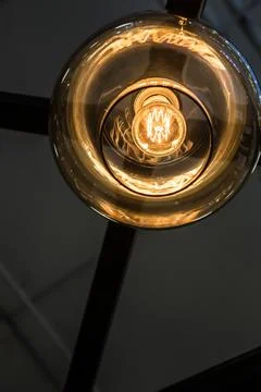 Glass ceiling with light bulb Edison close-up Stock Photos