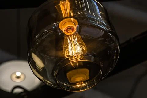 Glass ceiling with light bulb Edison close-up Stock Photos