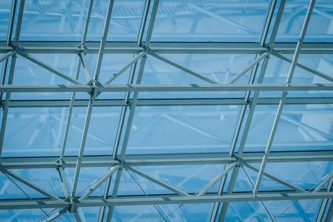 Glass ceiling structure with metal framework allowing natural light to filt.. 库存照片