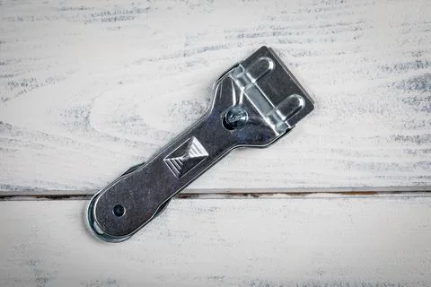 Glass ceramic scraper on a white wooden background Stock Photos