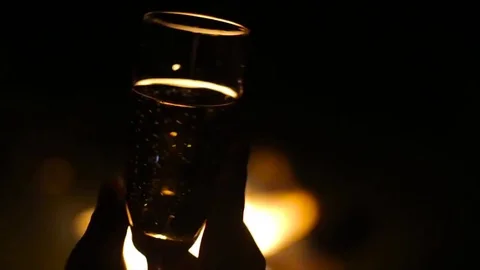 Glass of champagne with flame on background Stock Footage 76298218