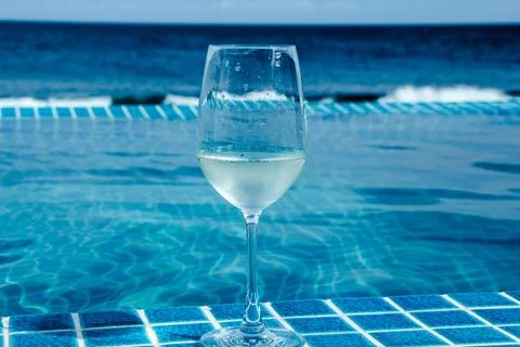 A glass of champagne by the pool Stock Photos