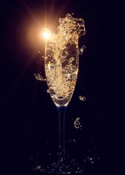 Glass of champagne with splashes Stock Photos