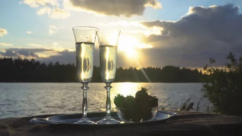 A glass of champagne at sunset Stock Footage 77117744