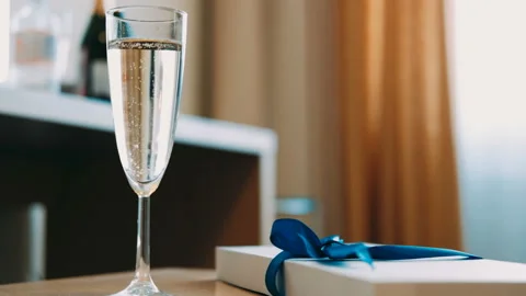 Glass of champagne on the table. bokeh, bubbles in a glass of champagne Stock-Footage 85704773