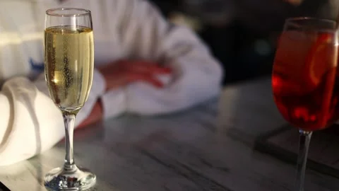 A glass of champagne on the table plays with bubbles Stock Footage 302765081