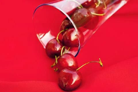 Glass of cherry  on a red background Stock Photos