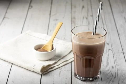 Glass with chocolate on the table. Stock Photos