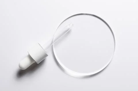 A glass circle on a white background. A template for placing samples of cosme Stock Photos