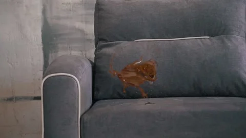 Glass with coffee fell on the sofa close-up Stock Footage 160938670
