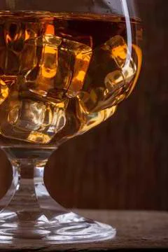 Glass of cognac with ice closeup  on cloth background Foto stock