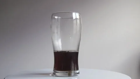 Glass of cola emptying itself, can be reversed for a filling glass Stock Footage 138896827