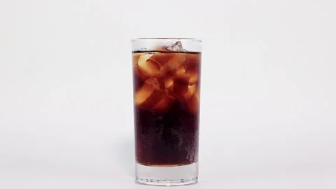Glass of cola with ice is filled with black cola on white background Stock-Footage 200866533