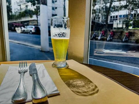 A glass of cold beer is on the table. Stock Photos