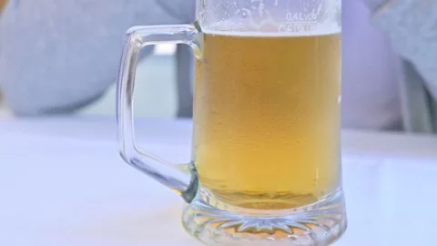 A glass of cold beer on a table in a restaurant. Stock Footage 131706273
